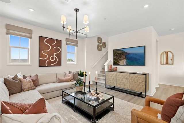 living room featuring light wood-type flooring and an inviting chandelier