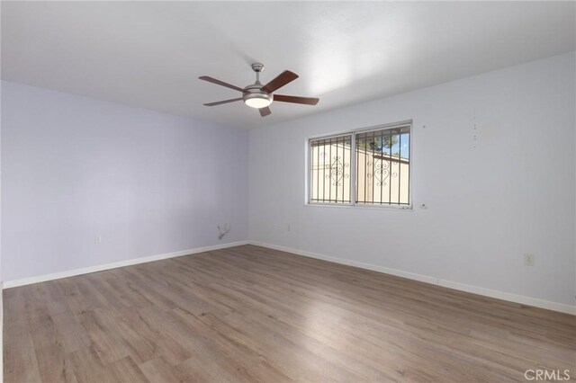 empty room with light hardwood / wood-style floors and ceiling fan