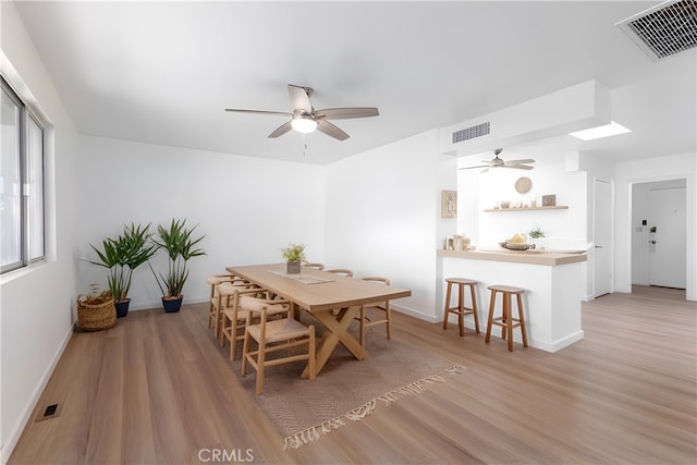 dining room with hardwood / wood-style floors and ceiling fan