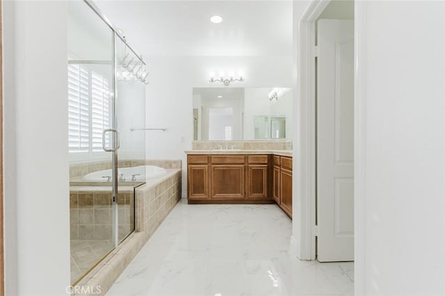 bathroom featuring separate shower and tub and vanity