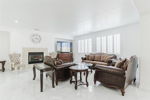 living room featuring a tile fireplace