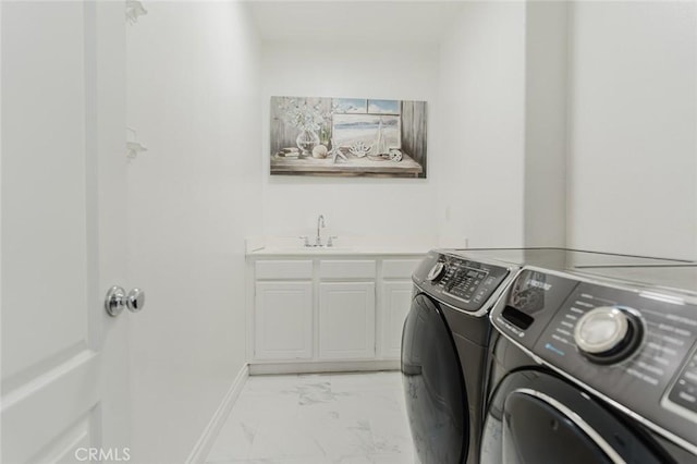 laundry area with washer and dryer, cabinets, and sink