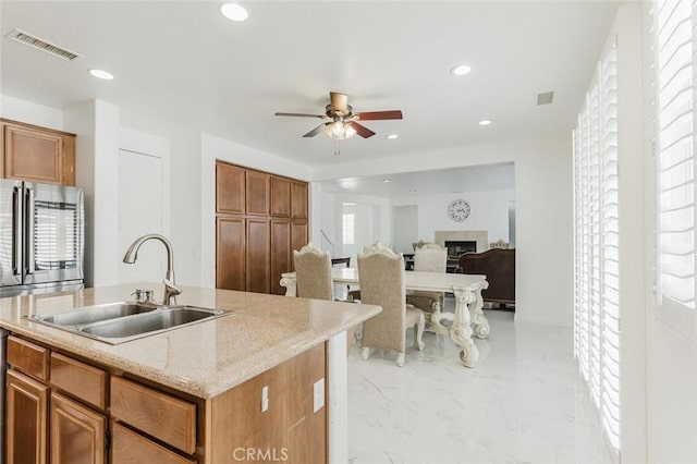 kitchen featuring an island with sink, plenty of natural light, and sink