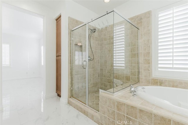 bathroom featuring shower with separate bathtub