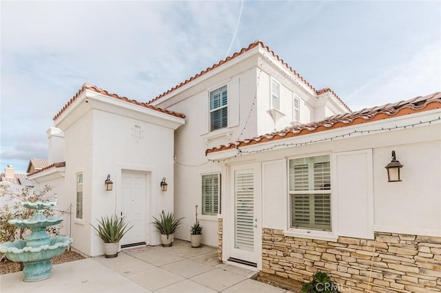 rear view of property featuring a patio area