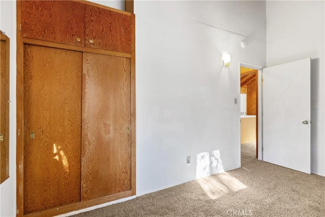 unfurnished bedroom featuring carpet floors and a closet