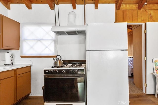 592 Mountain View Ave, Wrightwood, CA 92397 - kitchen featuring white appliances, beam ceiling, island exhaust hood, dark wood-type flooring, and light countertops