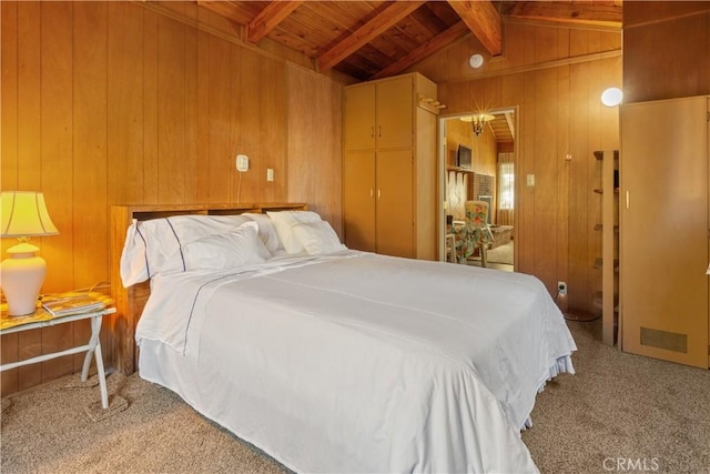 bedroom featuring vaulted ceiling with beams, wooden walls, carpet floors, and wood ceiling