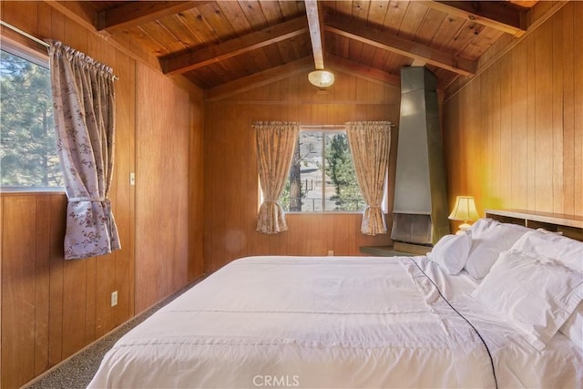 bedroom featuring carpet flooring, wooden walls, lofted ceiling with beams, and wooden ceiling