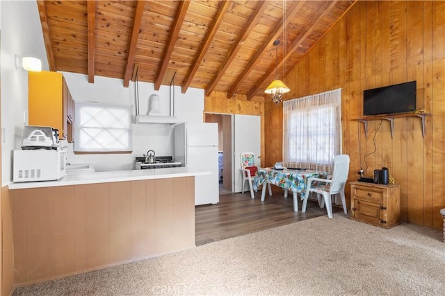 kitchen featuring kitchen peninsula, dark hardwood / wood-style flooring, white appliances, lofted ceiling with beams, and wooden ceiling