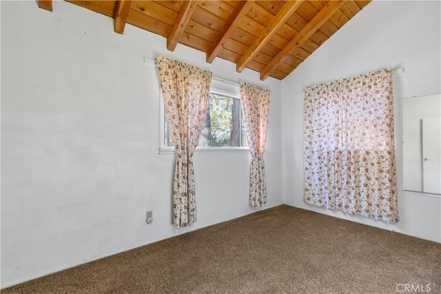 empty room featuring vaulted ceiling with beams, carpet, and wooden ceiling