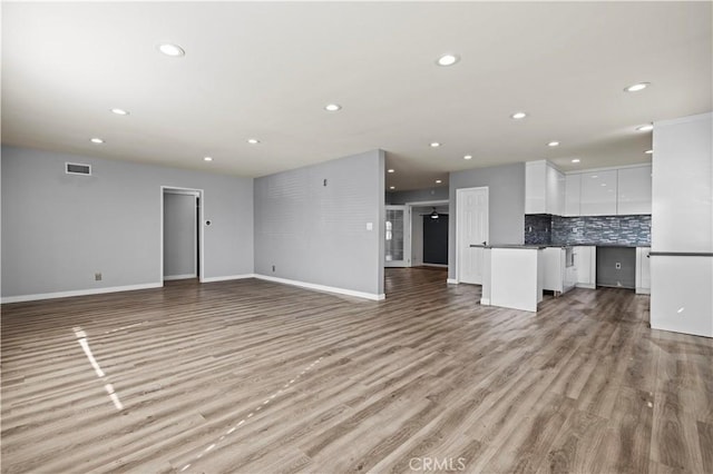 unfurnished living room with light hardwood / wood-style flooring