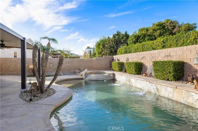 view of pool featuring pool water feature and an in ground hot tub