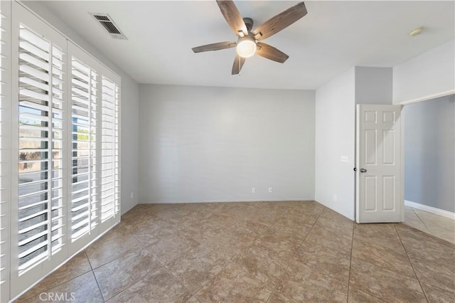 spare room featuring light tile patterned floors and ceiling fan