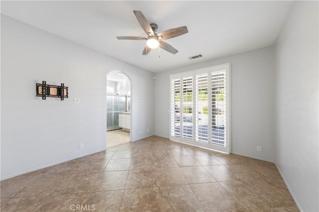 empty room featuring light tile patterned floors and ceiling fan