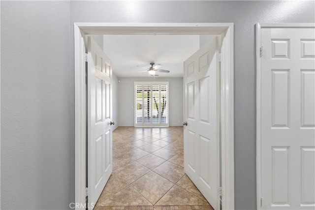 hall featuring light tile patterned floors