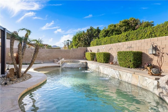 view of swimming pool with pool water feature and an in ground hot tub