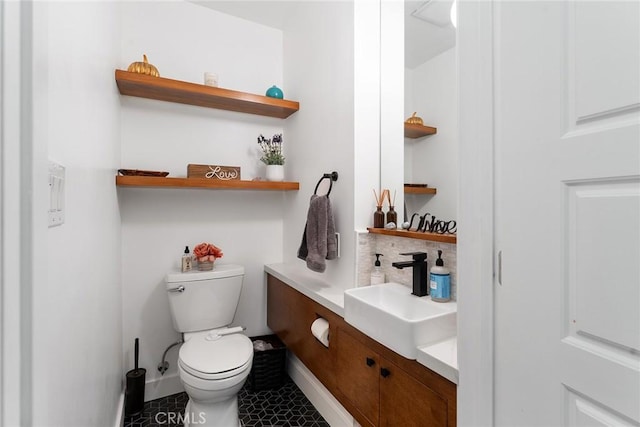 bathroom featuring tile patterned flooring, vanity, backsplash, and toilet