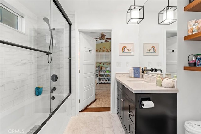 bathroom featuring shower / bath combination with glass door, ceiling fan, vanity, and hardwood / wood-style flooring