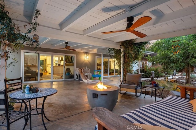 view of patio / terrace with ceiling fan and an outdoor fire pit