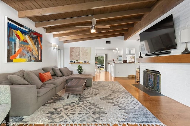 living room featuring hardwood / wood-style flooring, lofted ceiling with beams, ceiling fan, and wooden ceiling