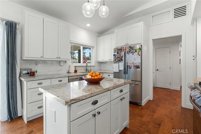 kitchen featuring a center island, dark wood-type flooring, white cabinets, hanging light fixtures, and stainless steel appliances