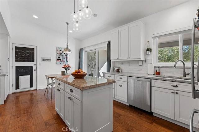 kitchen with dishwasher, a kitchen island, white cabinetry, and dark wood-type flooring