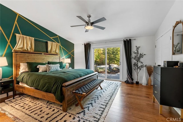 bedroom featuring wood-type flooring, access to outside, vaulted ceiling, and ceiling fan