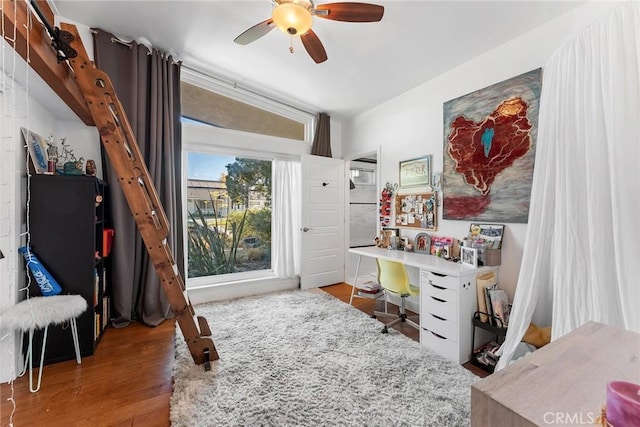 interior space featuring hardwood / wood-style floors, vaulted ceiling, and ceiling fan