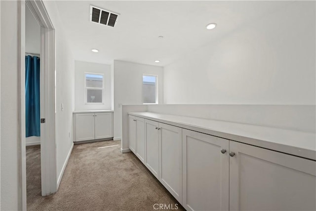 hallway featuring light carpet