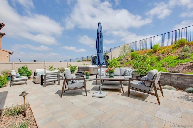 view of patio featuring an outdoor living space and a hot tub