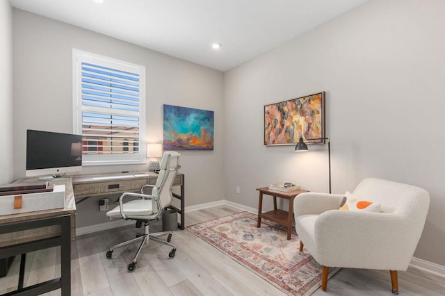 home office with light hardwood / wood-style floors