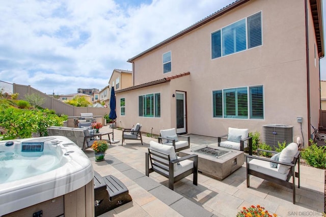 exterior space featuring an outdoor living space with a fire pit, a hot tub, grilling area, and central AC