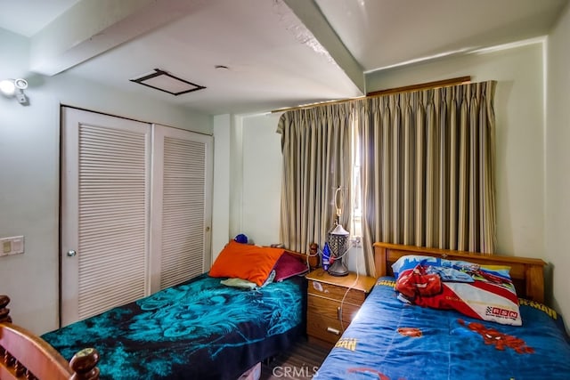 bedroom featuring a closet, beamed ceiling, and dark hardwood / wood-style floors