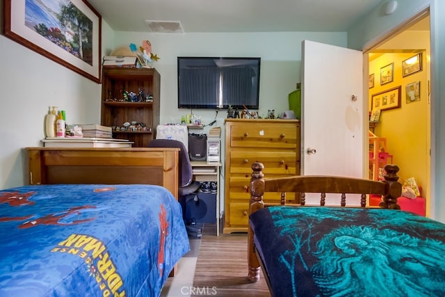 bedroom with wood-type flooring