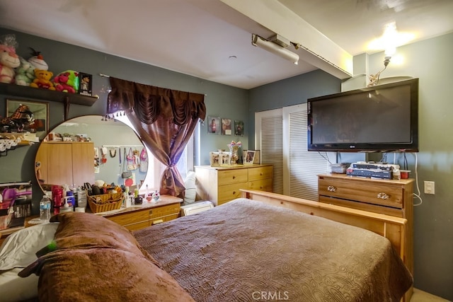 bedroom featuring beam ceiling