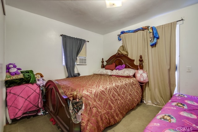 bedroom with cooling unit and carpet floors