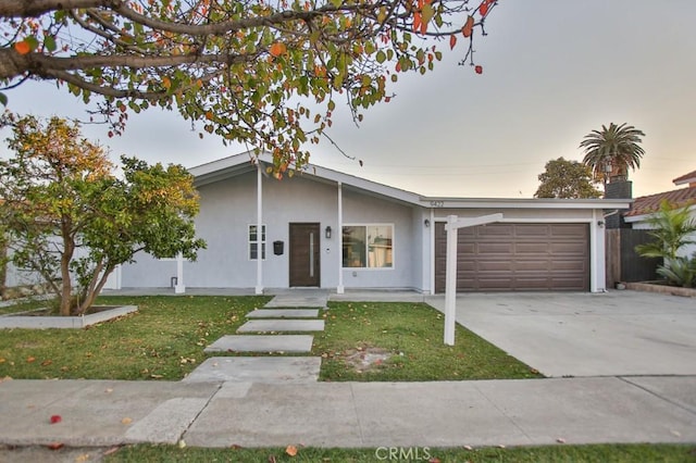 ranch-style house with a lawn and a garage