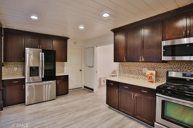 kitchen with appliances with stainless steel finishes and dark brown cabinets