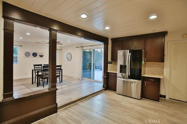 kitchen featuring stainless steel refrigerator with ice dispenser, ceiling fan, decorative backsplash, and plenty of natural light