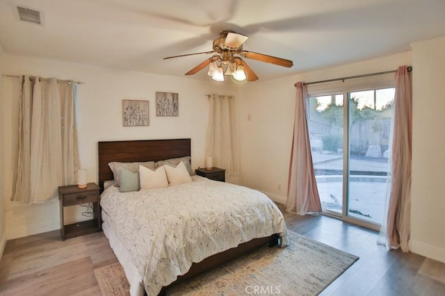 bedroom featuring access to outside, ceiling fan, and light wood-type flooring