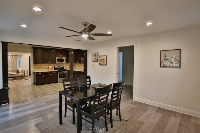 dining space featuring light wood-type flooring and ceiling fan