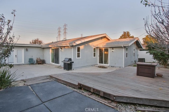 rear view of property featuring a wooden deck