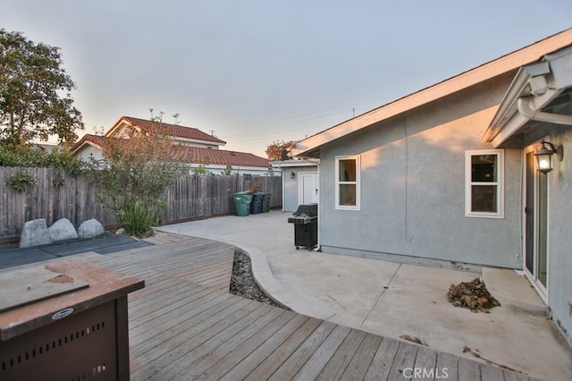 deck at dusk with grilling area