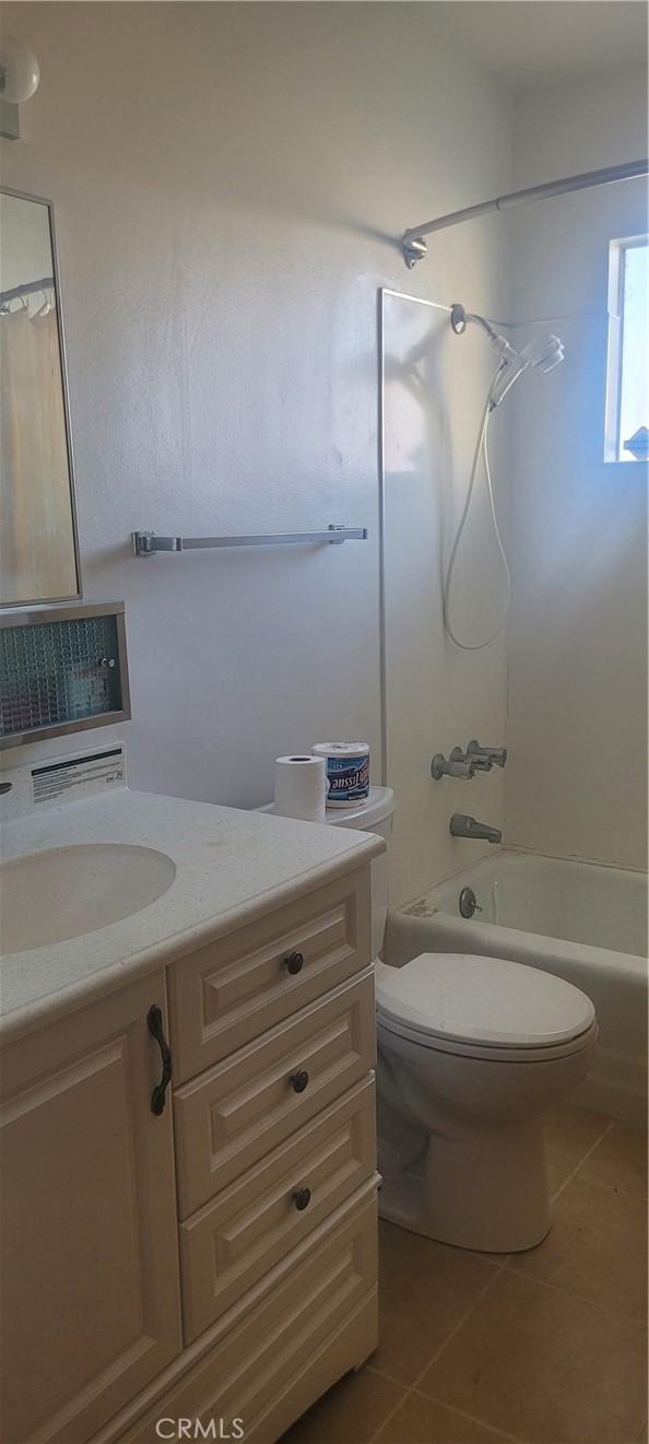 full bathroom featuring shower / bathtub combination, tile patterned floors, vanity, and toilet