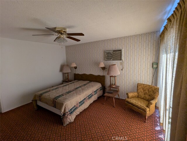 bedroom with ceiling fan and a textured ceiling