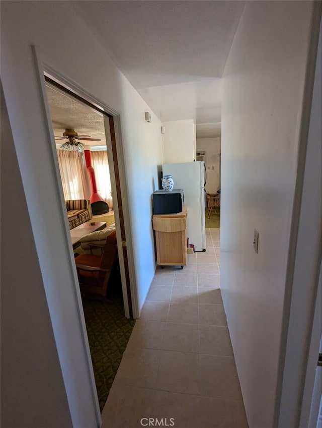 hall featuring light tile patterned flooring