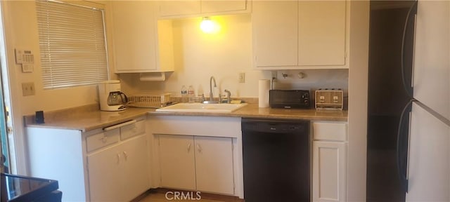 kitchen with white cabinets, refrigerator, dishwasher, and sink