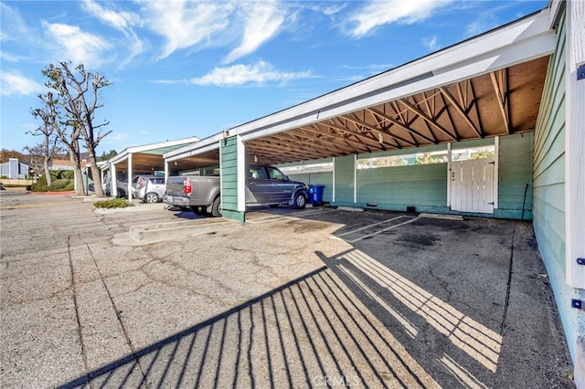 view of vehicle parking featuring a carport