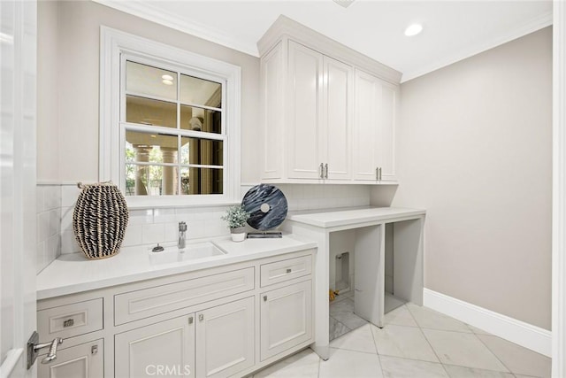 washroom featuring crown molding, sink, and light tile patterned flooring